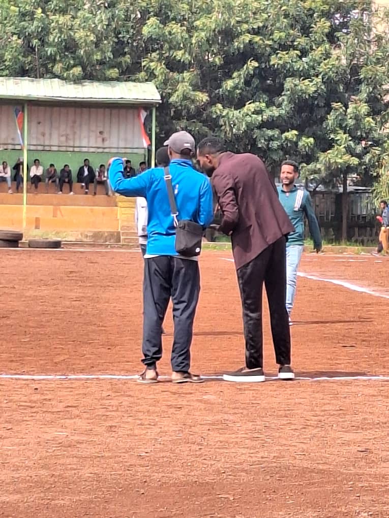 Club members at the sideline of a football field