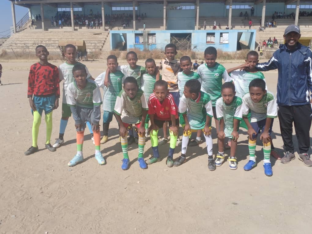 Green Star FC team standing together at a football ground