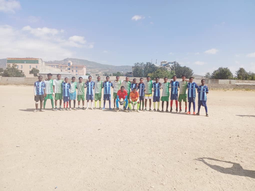 Two football teams line up together on a field
