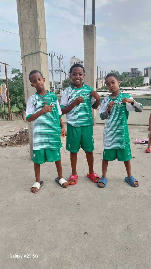 Three young players wearing green and white Green Star kits